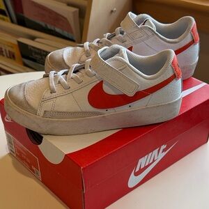 Nike White Low-Top Sneakers with Orange Swoosh
